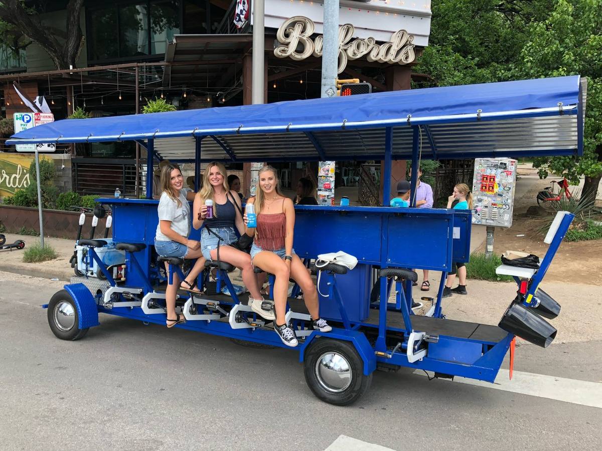 Friends celebrating a 21st birthday on the downtown Austin party bike